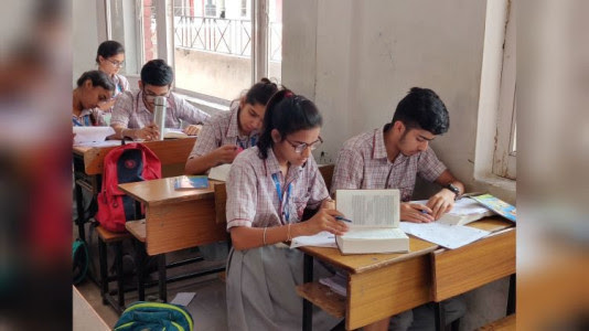Students at a Delhi school refer to the Bhagavad-gita while taking an offline exam in 2019